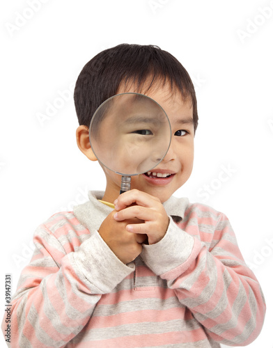 smiling boy holding magnifier