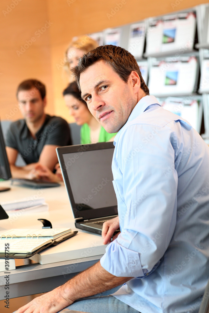 Man sitting in office in front of laptop computer Man sitting in office in front of laptop computer