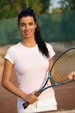 Beautiful female tennis player smiling
