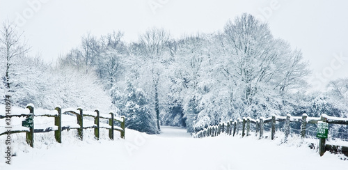 Path through English rural countryside in Winter with snow