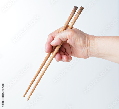 hand using chopsticks
