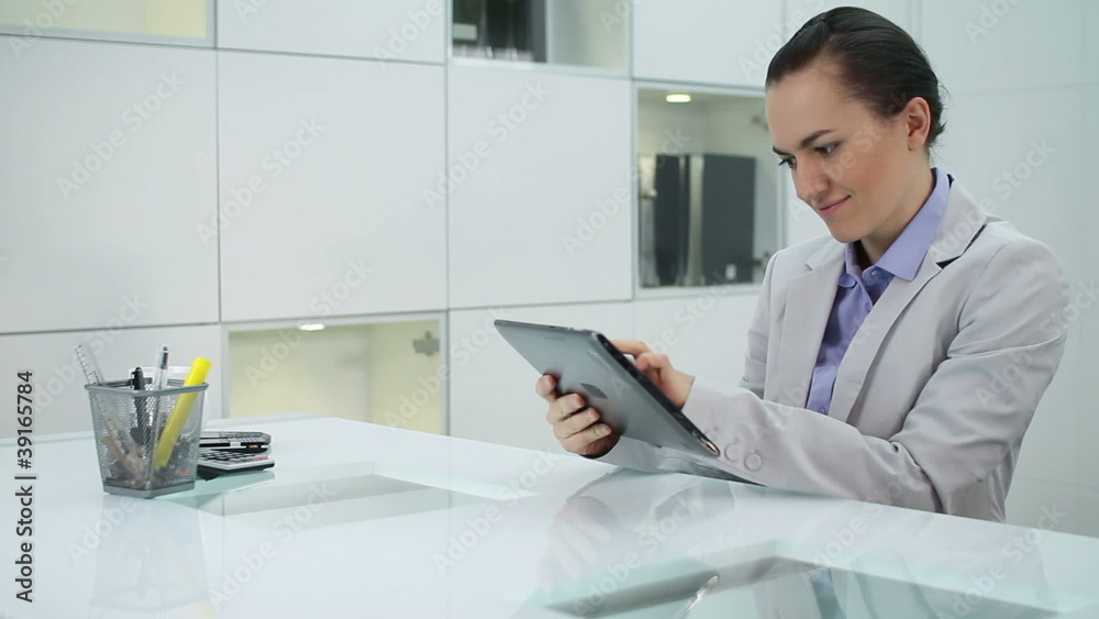 Young businesswoman with tablet computer in modern office Young businesswoman with tablet computer in modern office