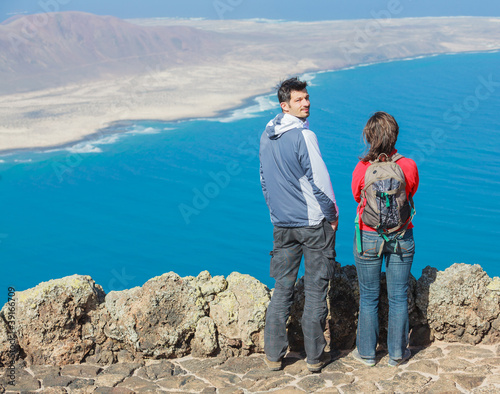 Sport couple standing on cliff's edge