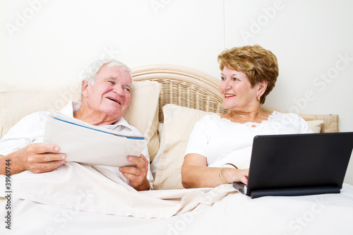 senior couple chatting in bed before sleep © michaeljung