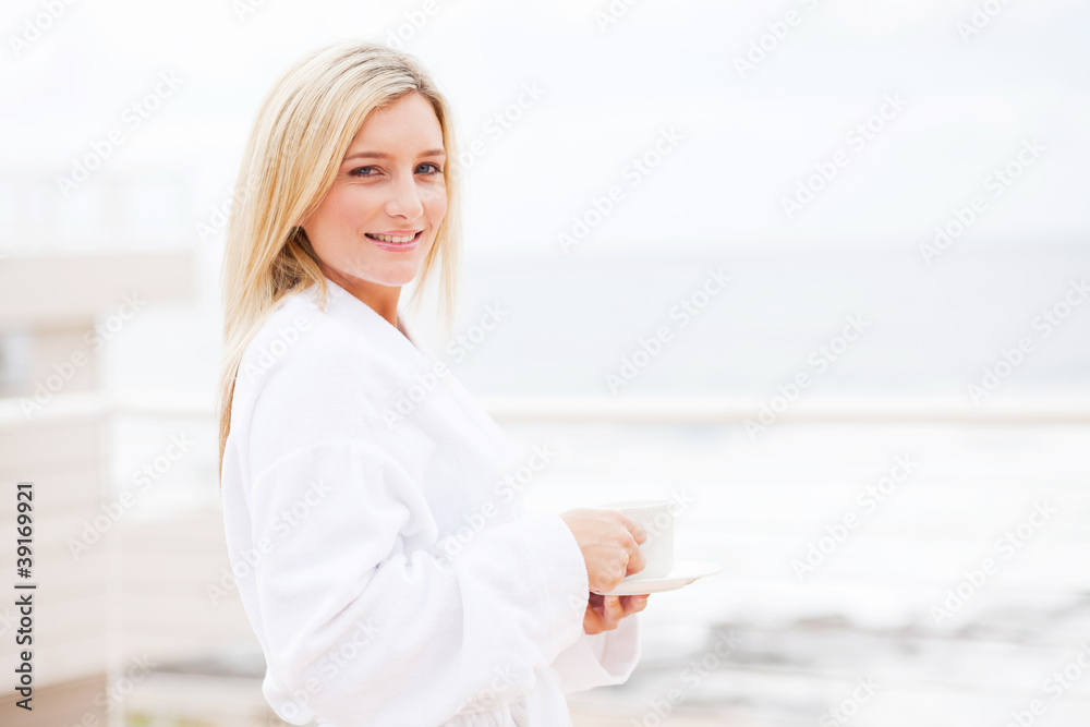 Fototapeta premium attractive young woman in bathrobe drinking coffee
