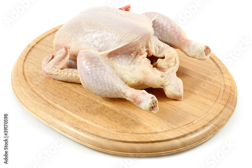 raw chicken on wooden hardboard isolated white background