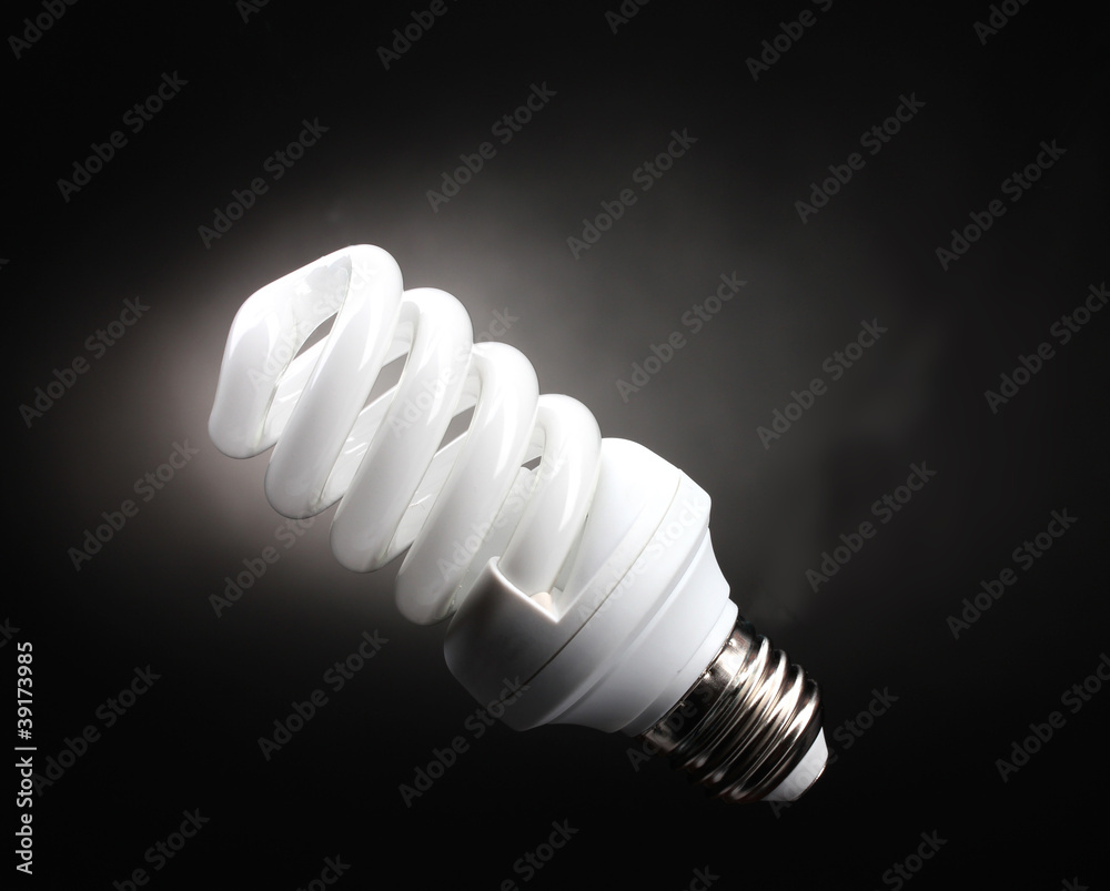 Energy saving lamp on black background Energy saving lamp on black background