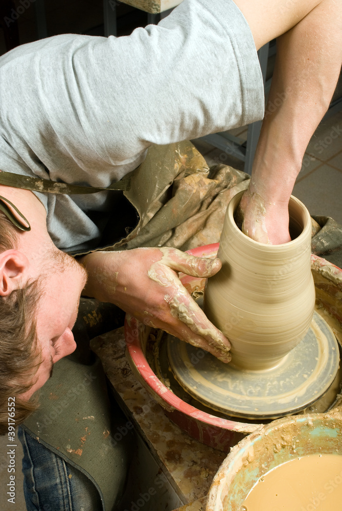 potter, creating an earthen jar of white clay