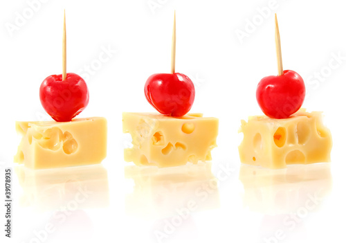 piece cheese with cocktail cherry isolated on white background