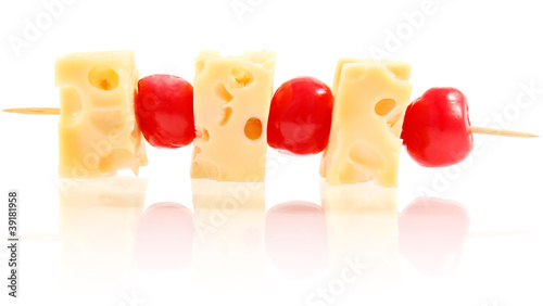 snack shish kebab of cheese and cherry isolated on white