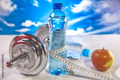 fitness barbell, water and apple
