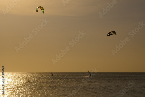 Kitesurfers silhouettes against sunset