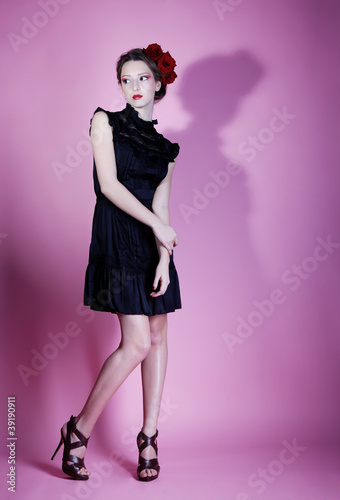 Beautiful girl with rose in hair