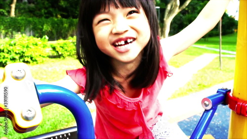 Asian girl playing at a playground