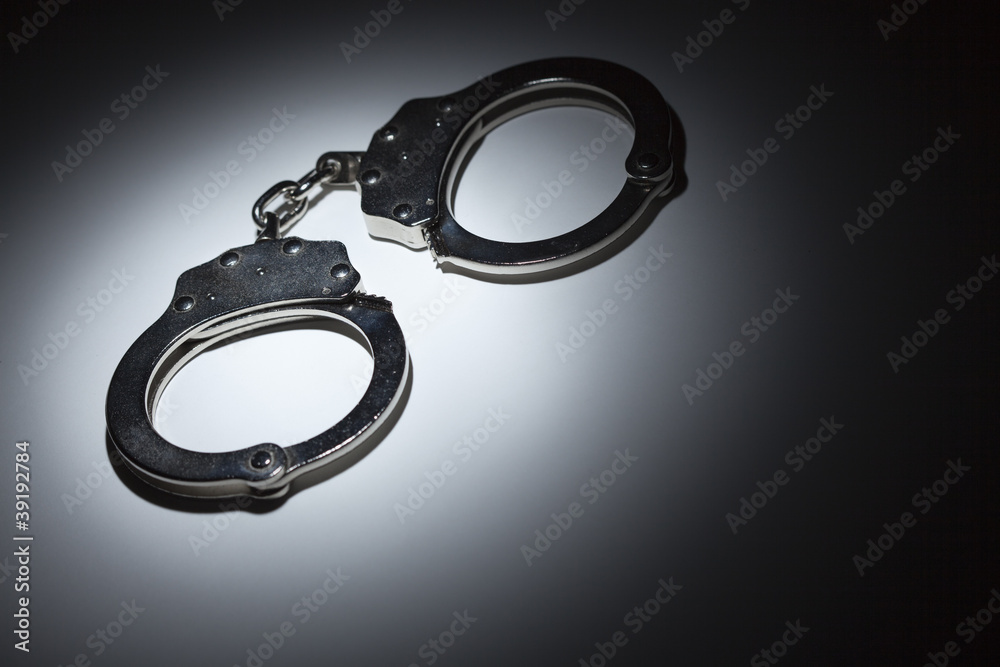 Abstract Pair of Handcuffs Under Spot Light - Text Room Abstract Pair of Handcuffs Under Spot Light - Text Room
