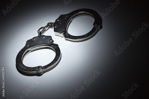 Abstract Pair of Handcuffs Under Spot Light - Text Room