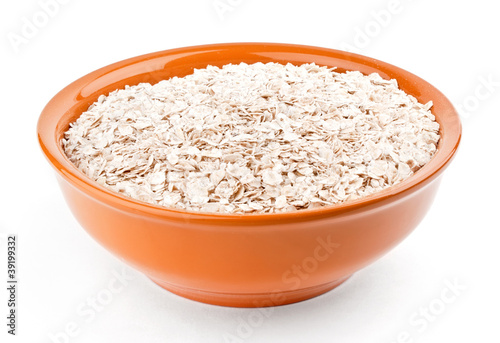 Oat-flakes in bowl on white background