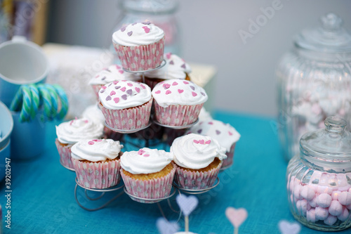Delicious colorful wedding cupcakes with hearts icing