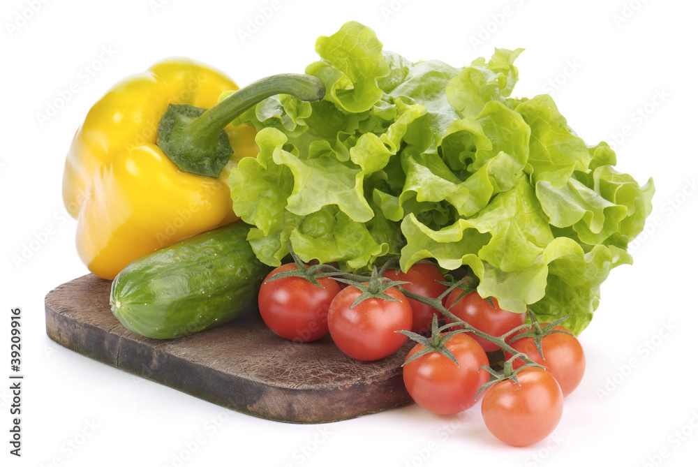 cherry tomatoes, salad and paprika on cutting board isolated on cherry tomatoes, salad and paprika on cutting board isolated on