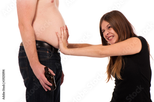 girl pushing against her boyfriends beer belly
