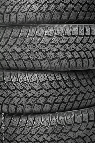Background of four car wheel winter tires