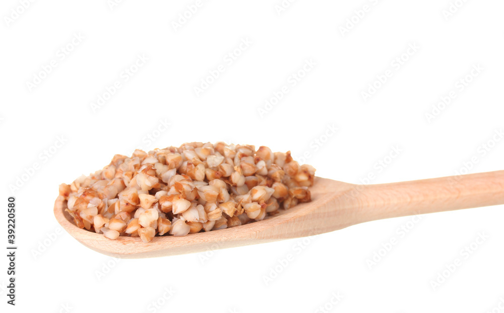 Wooden spoon with boiled buckwheat isolated on white Wooden spoon with boiled buckwheat isolated on white