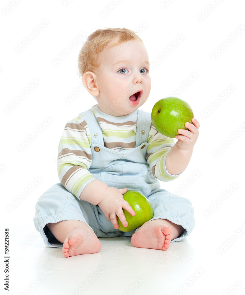 Fototapeta premium Baby boy eating healthy food isolated