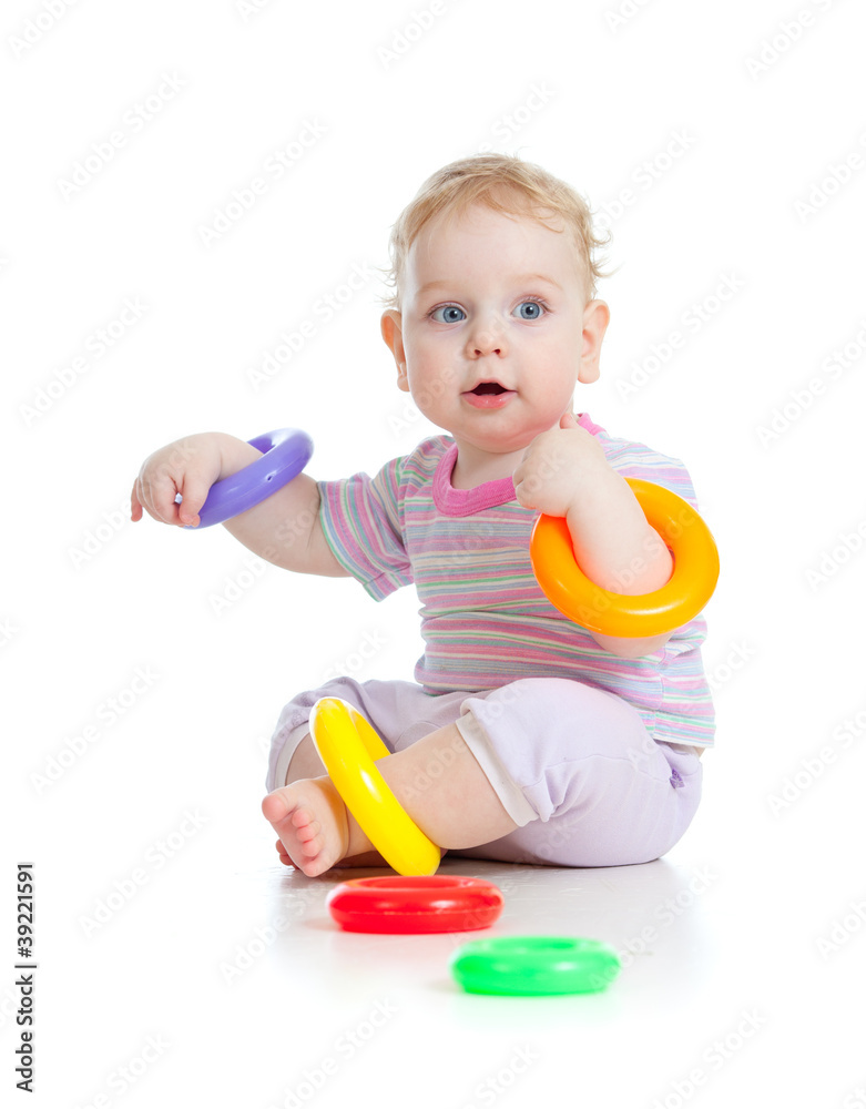 Cute little boy playing colorful toys isolated on white Cute little boy playing colorful toys isolated on white