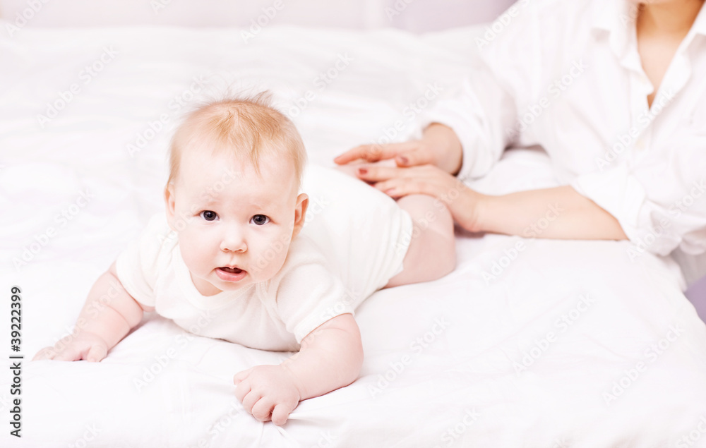 Mother massaging and exercise her little baby