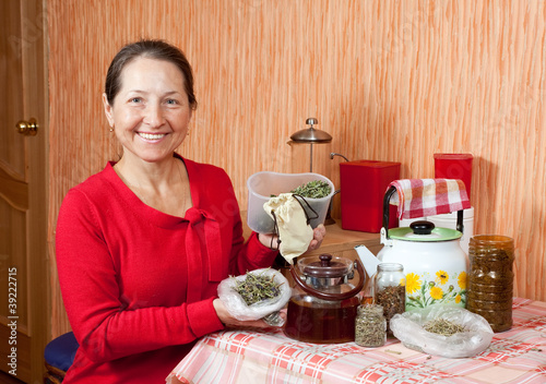 Mature woman brews herbs photo