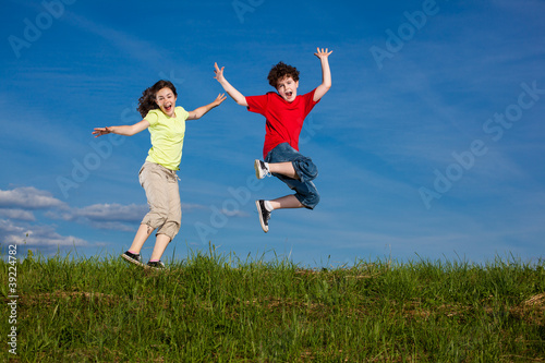 Girl and boy running, jumping outdoor