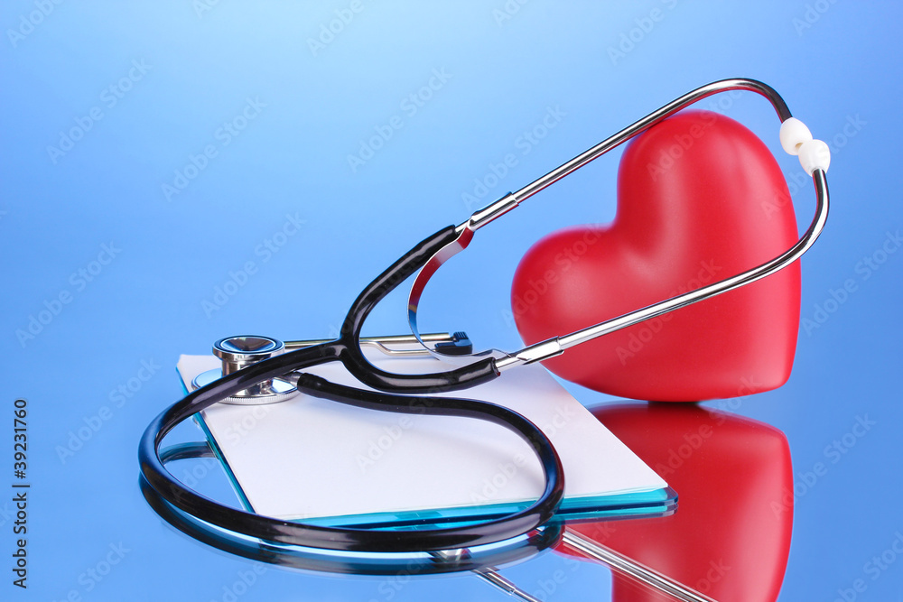 Medical stethoscope with clipboard and heart on blue background Medical stethoscope with clipboard and heart on blue background