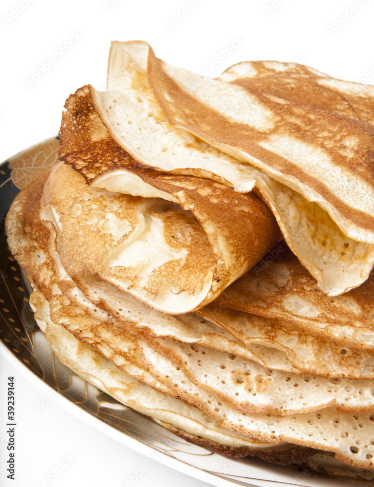 Fresh hot pancakes on a plate on a white background
