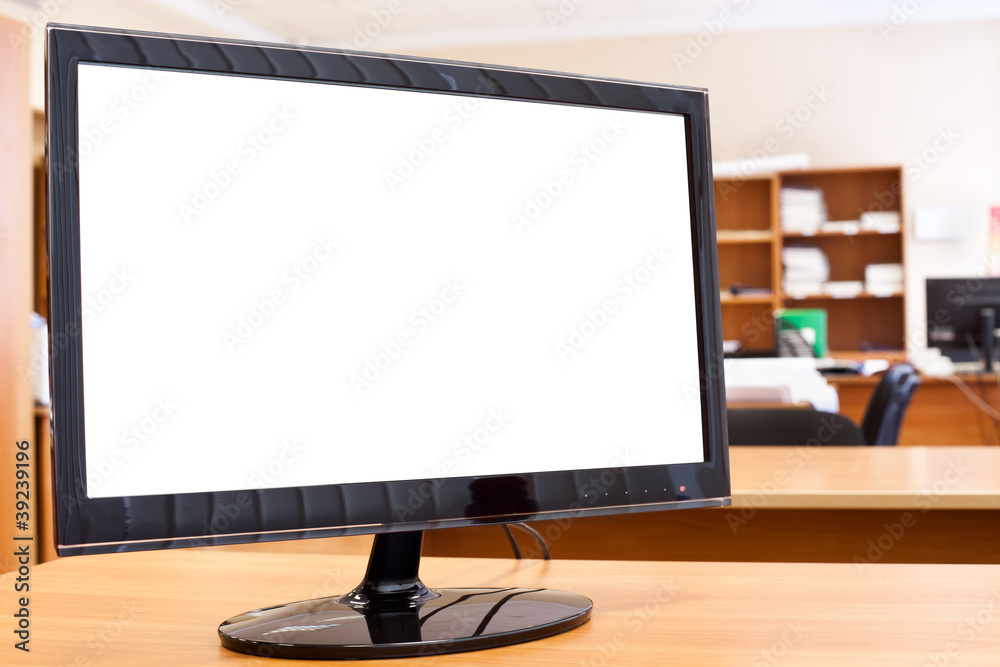 Fototapeta premium Computer monitor with isolated screen on desktop in office room