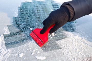 Scraping ice from the car window