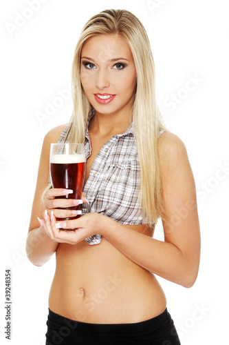 Sexy young blond woman holding glass of beer