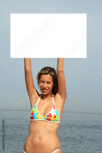 A gorgeous model holding a blank sign in the air