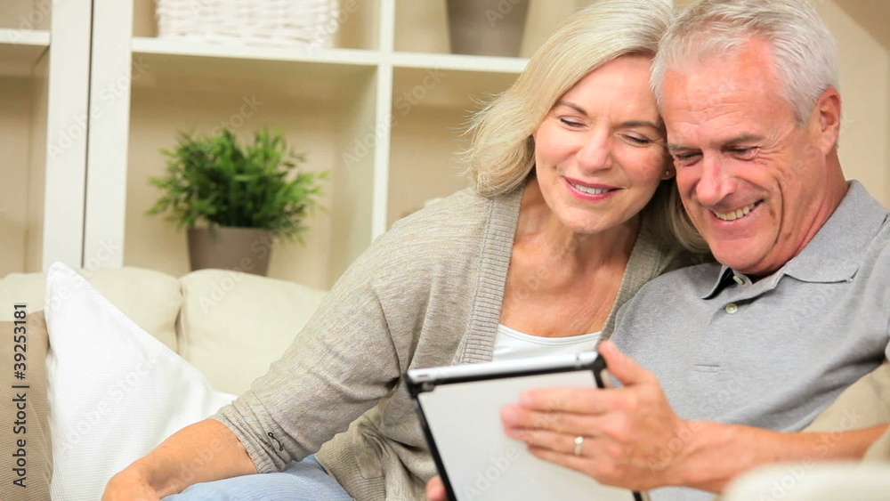 Retired Caucasian Couple Using a Wireless Tablet Retired Caucasian Couple Using a Wireless Tablet