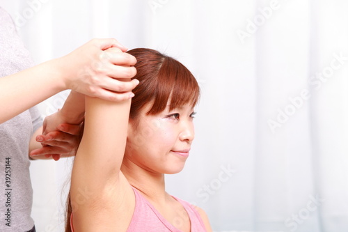 young japanese woman getting chiropractic