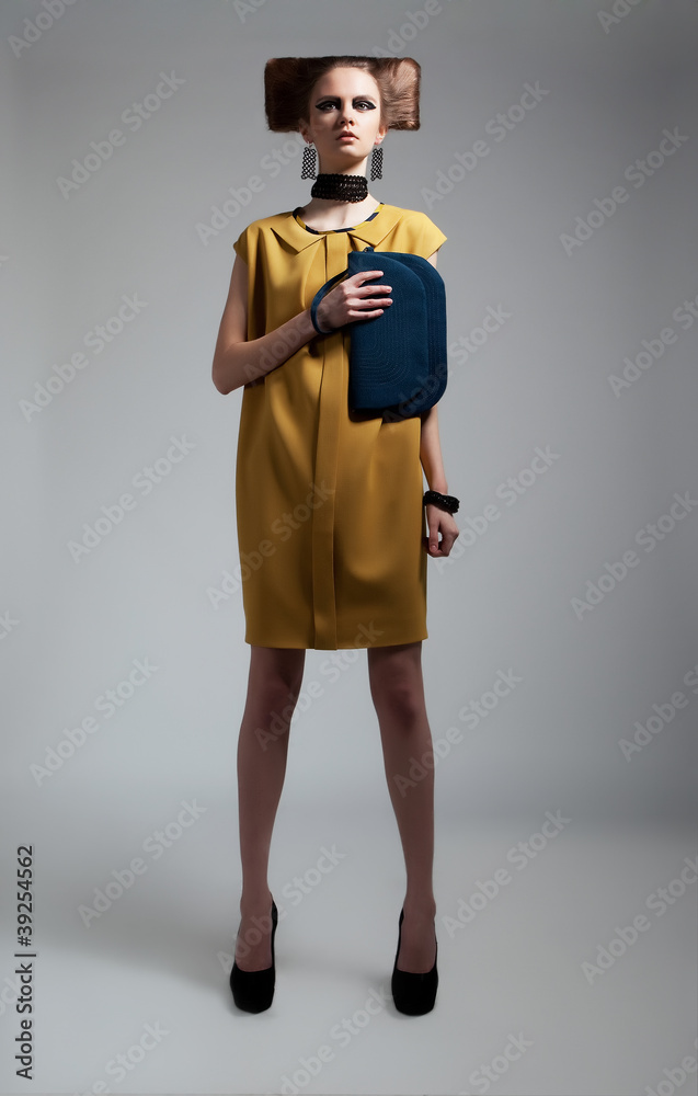 Young pretty stylish woman in a fashionable dress posing Young pretty stylish woman in a fashionable dress posing