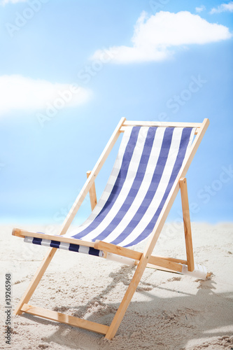 Fototapeta Naklejka Na Ścianę i Meble -  Deckchair standing at the sunny beach