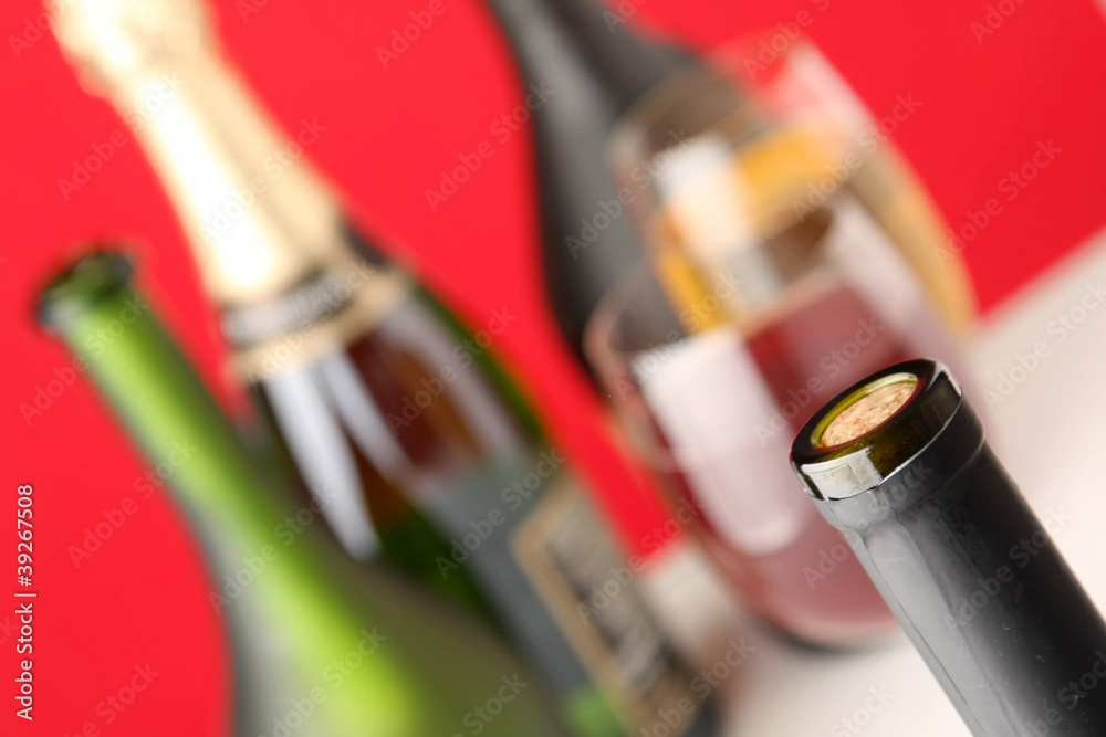 Fototapeta premium Still life with bottles, glasses, focus on a bottle with a cork