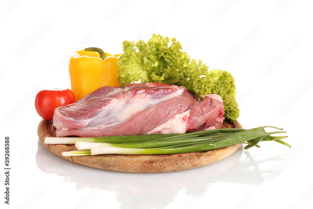 Raw meat and vegetables on a wooden board isolated on whitе Raw meat and vegetables on a wooden board isolated on whitе
