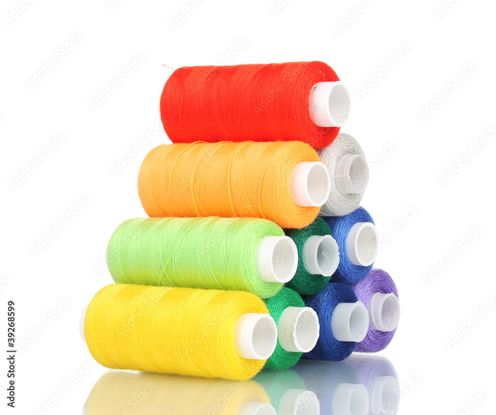 Pyramid of many-coloured bobbins of thread isolated on white Pyramid of many-coloured bobbins of thread isolated on white