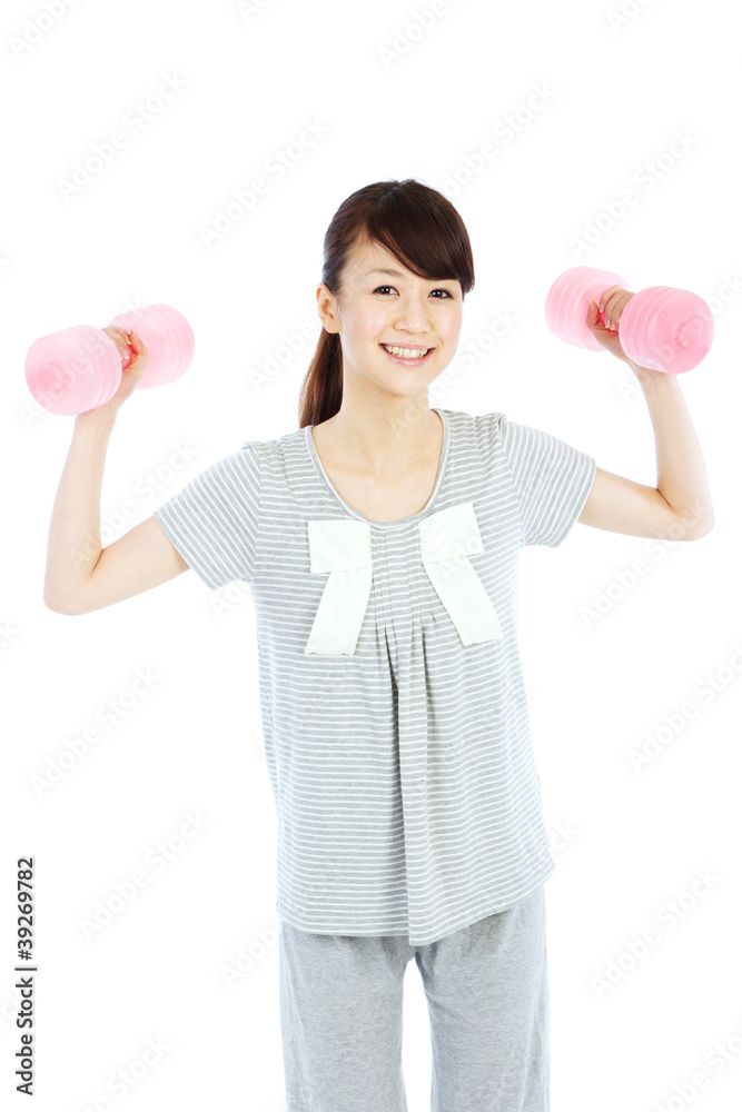 Beautiful young woman with dumbbells in her hands Beautiful young woman with dumbbells in her hands