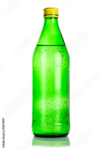 Green glass bottle of mineral water on white background