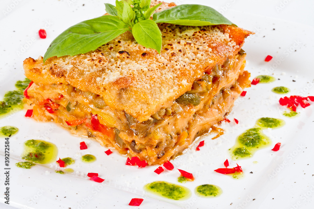 Closeup of lasagna and basil fork Closeup of lasagna and basil fork