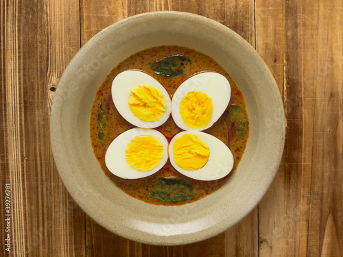 close up of a bowl of indian egg curry photo