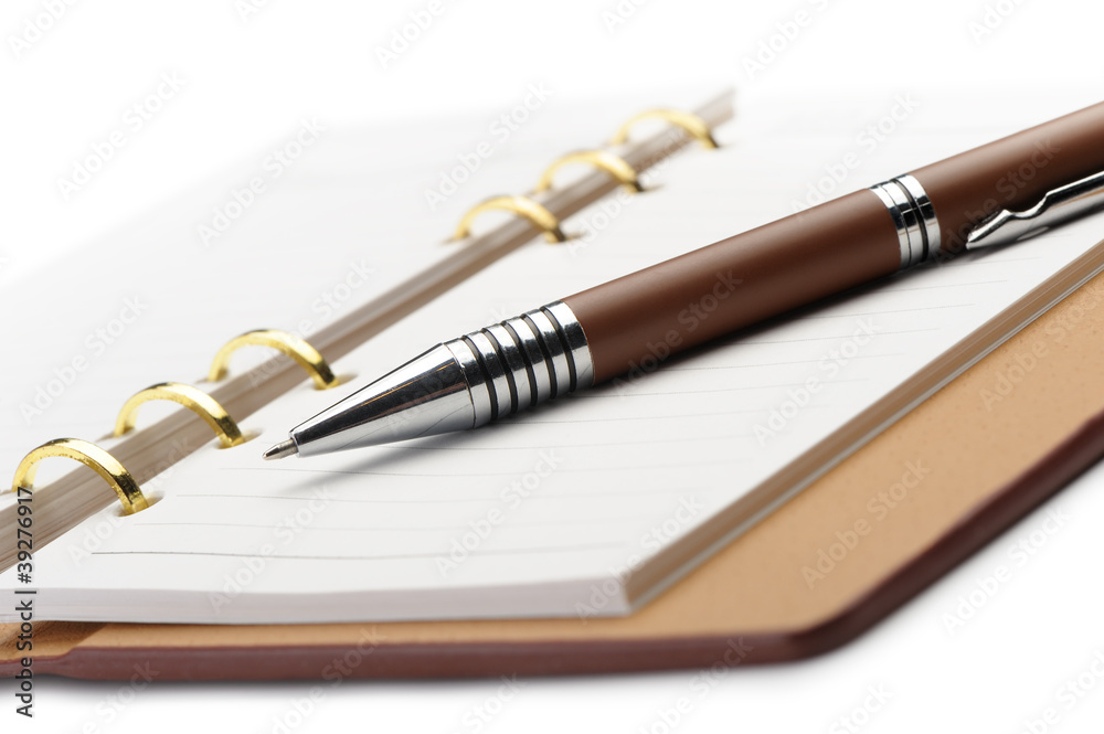 Fototapeta premium Open notebook with copper binding and stylish pen