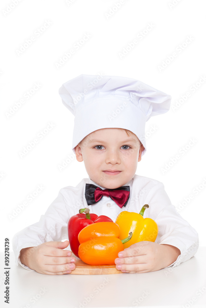 Boy with clothes cooks with vegetables Boy with clothes cooks with vegetables
